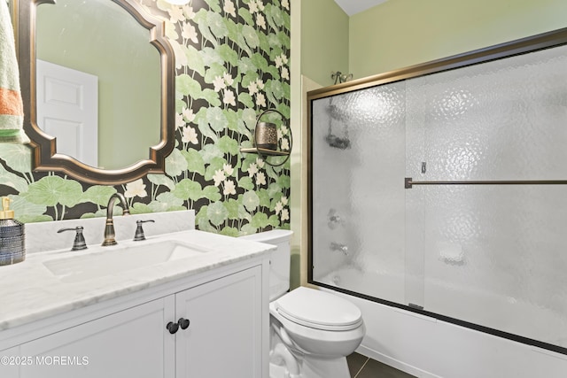 full bathroom with tile patterned flooring, vanity, shower / bath combination with glass door, and toilet