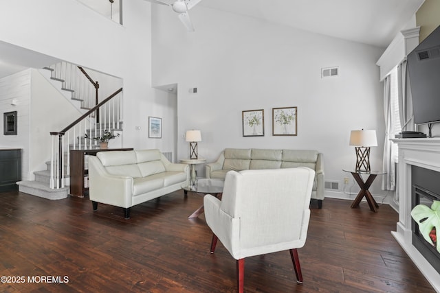 living room with high vaulted ceiling and dark hardwood / wood-style floors