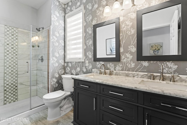 bathroom with a shower with door, vanity, hardwood / wood-style flooring, and toilet