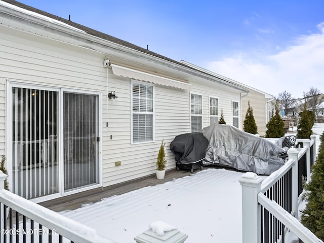 snow covered deck featuring area for grilling