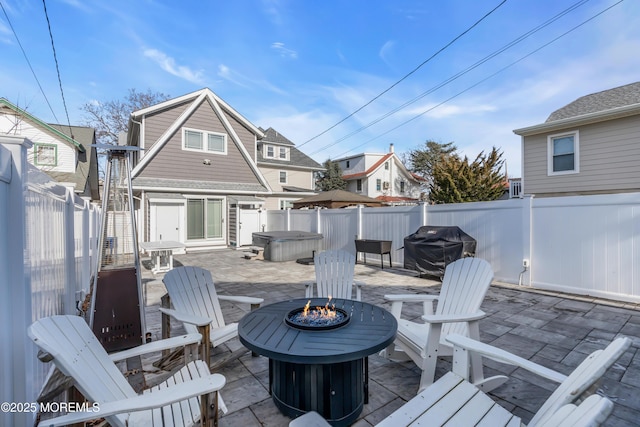 wooden deck featuring grilling area, an outdoor fire pit, and a patio