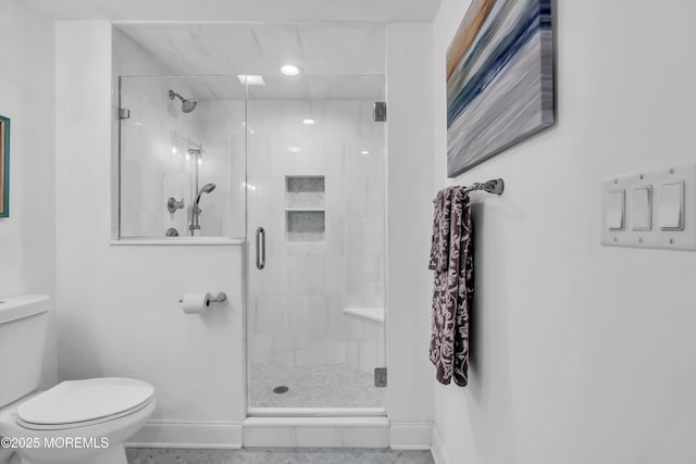 bathroom with an enclosed shower and toilet