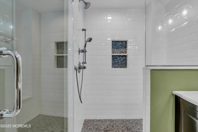 bathroom with vanity and a shower with shower door