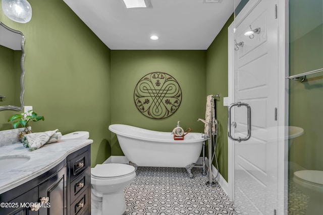 bathroom featuring a tub to relax in, toilet, and vanity