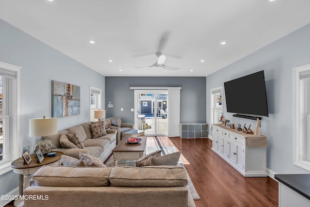 living room with ceiling fan and dark hardwood / wood-style flooring