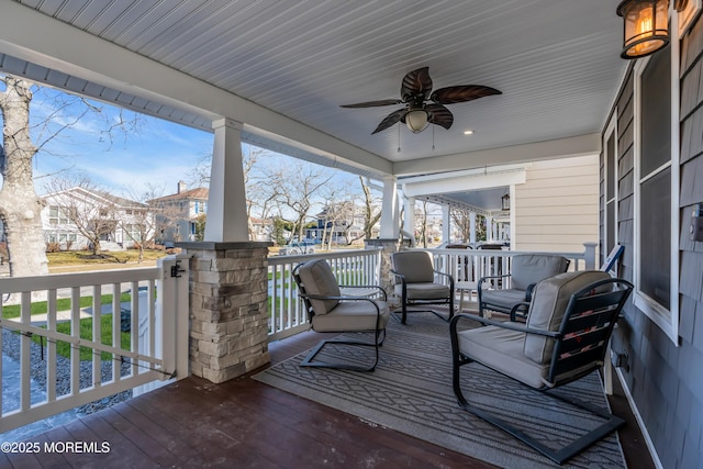 wooden deck featuring a porch and ceiling fan