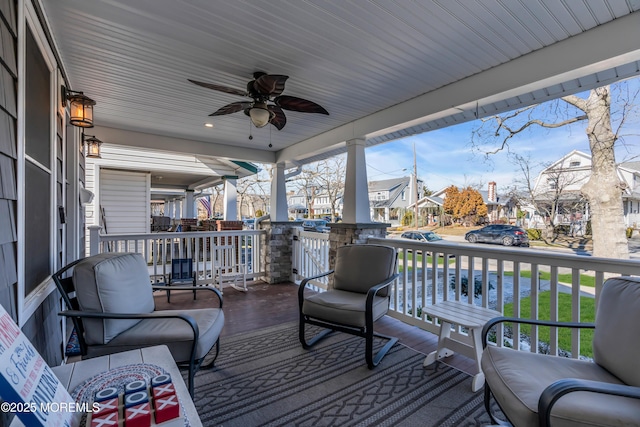 wooden terrace with a porch and ceiling fan