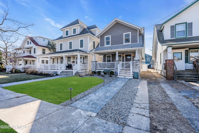 view of front of house featuring a front lawn and covered porch