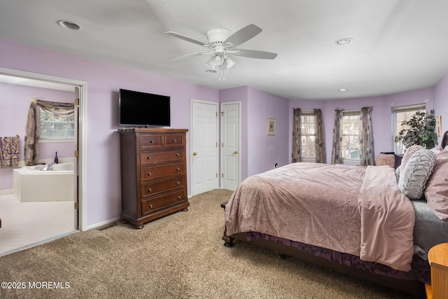 bedroom with ceiling fan, connected bathroom, and carpet floors