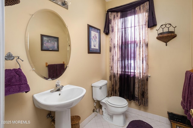 bathroom with sink, tile patterned floors, and toilet