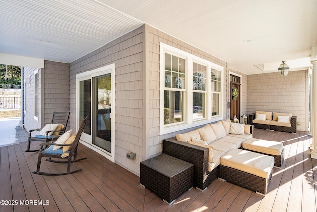 wooden deck featuring a porch and an outdoor hangout area