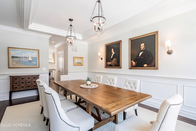 dining space featuring hardwood / wood-style floors and crown molding