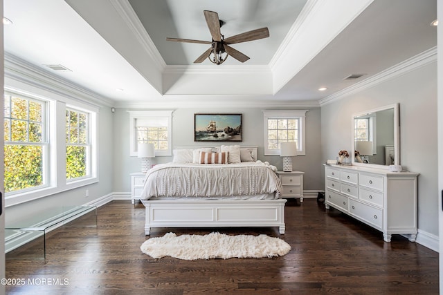 bedroom featuring a raised ceiling, crown molding, dark hardwood / wood-style floors, and ceiling fan