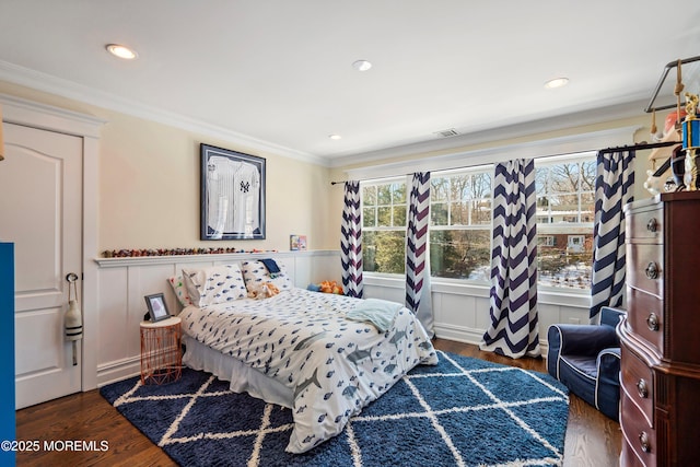 bedroom with crown molding and dark wood-type flooring