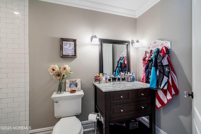 bathroom with crown molding, vanity, and toilet