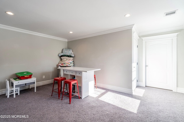 carpeted dining area featuring crown molding