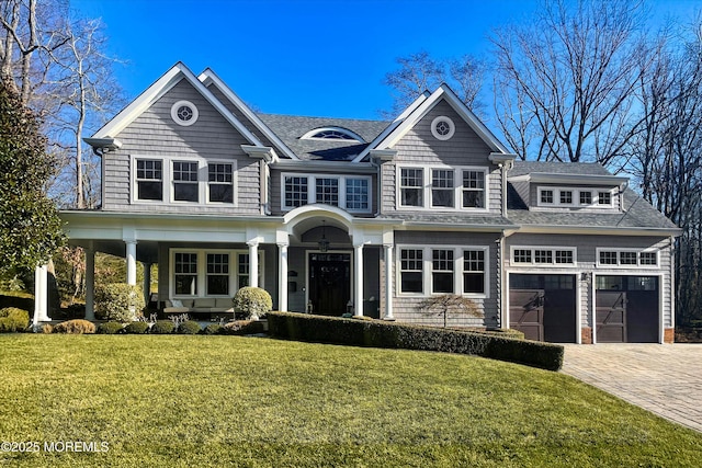 view of front of property with a garage and a front lawn