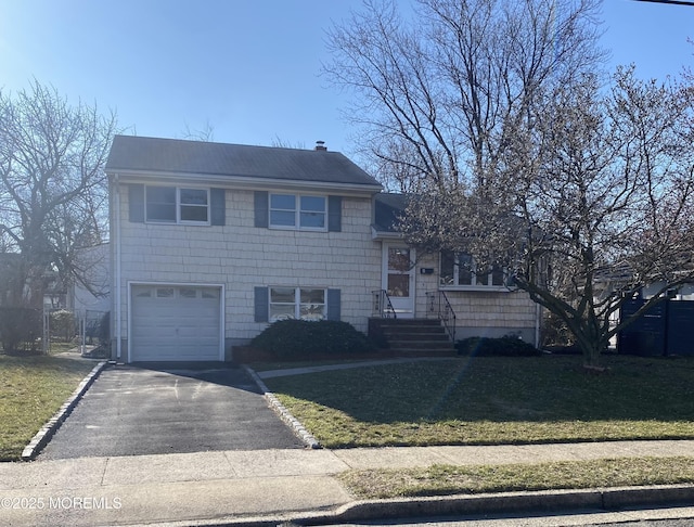 view of front of property featuring a garage and a front yard