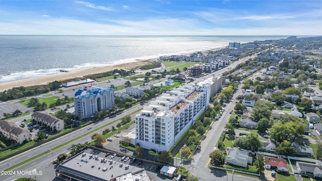 drone / aerial view with a water view and a view of the beach