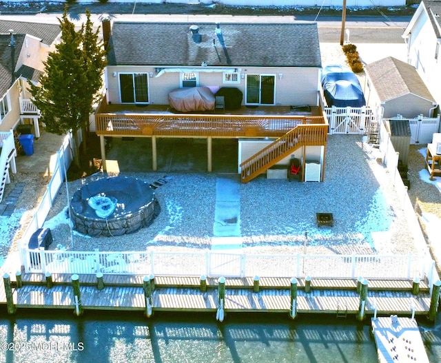 rear view of property with a fire pit