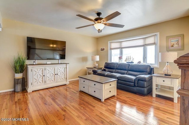 living room with ceiling fan and light hardwood / wood-style flooring