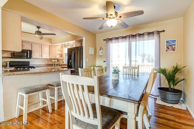 dining room featuring ceiling fan and dark hardwood / wood-style flooring