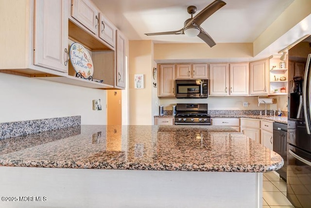 kitchen with light tile patterned floors, ceiling fan, kitchen peninsula, stainless steel appliances, and light stone countertops