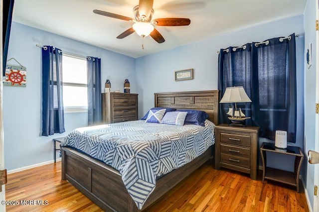 bedroom with hardwood / wood-style floors and ceiling fan