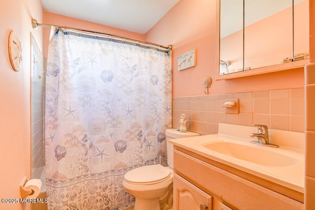 bathroom featuring vanity, a shower with curtain, toilet, and tile walls