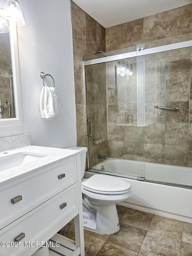 full bathroom with bath / shower combo with glass door, vanity, and toilet