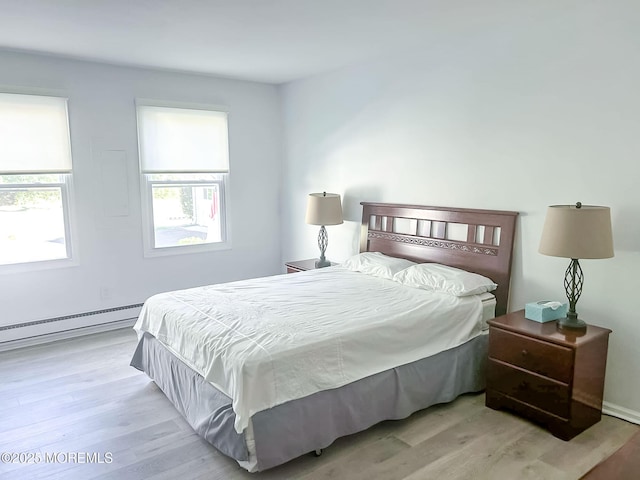 bedroom featuring a baseboard radiator and light hardwood / wood-style floors