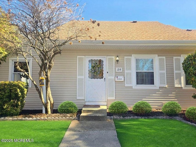 19B Plaza Del Campillo Unit 1000, Freehold, NJ 07728 - view of exterior entry with a yard and a shingled roof