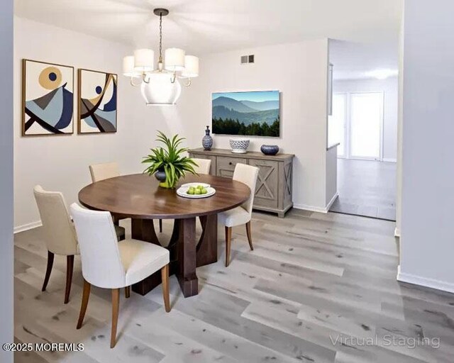 19B Plaza Del Campillo Unit 1000, Freehold, NJ 07728 - dining area featuring a chandelier and light wood-style flooring