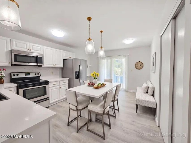 19B Plaza Del Campillo Unit 1000, Freehold, NJ 07728 - kitchen featuring appliances with stainless steel finishes, light countertops, and light wood-style flooring