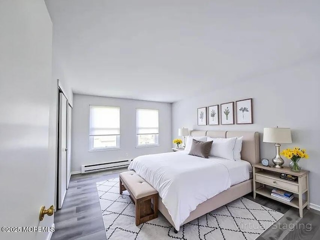 19B Plaza Del Campillo Unit 1000, Freehold, NJ 07728 - bedroom with baseboard heating and light wood-style flooring