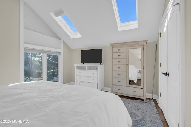 bedroom featuring dark hardwood / wood-style floors and vaulted ceiling with skylight