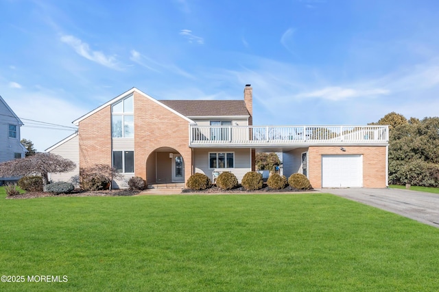 view of front property featuring a balcony, a garage, and a front lawn