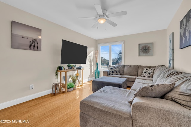 living room featuring wood-type flooring and ceiling fan