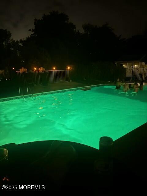 view of pool at twilight