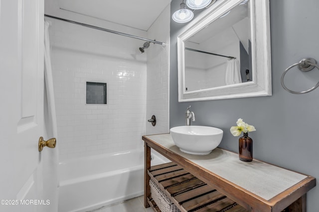 bathroom with shower / tub combo and sink