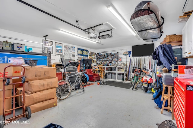 garage featuring a garage door opener and a workshop area