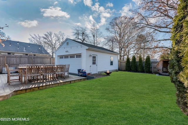 view of yard featuring an outbuilding, a garage, and a wooden deck