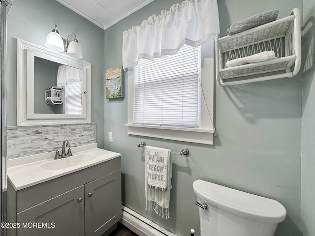 bathroom featuring crown molding, vanity, toilet, and backsplash