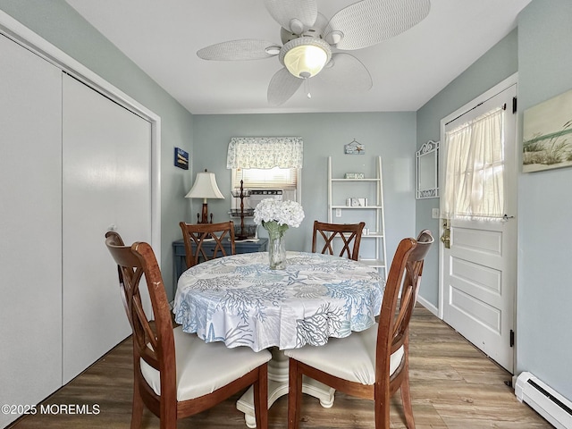 dining area featuring ceiling fan, hardwood / wood-style floors, and baseboard heating