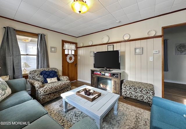 living room featuring hardwood / wood-style flooring and crown molding