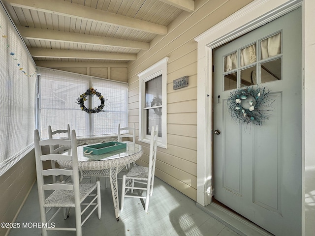 sunroom / solarium featuring wood ceiling and vaulted ceiling with beams