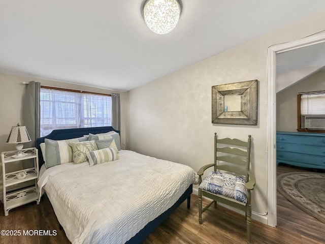 bedroom featuring cooling unit and dark hardwood / wood-style flooring