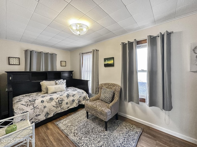 bedroom with crown molding and dark hardwood / wood-style flooring