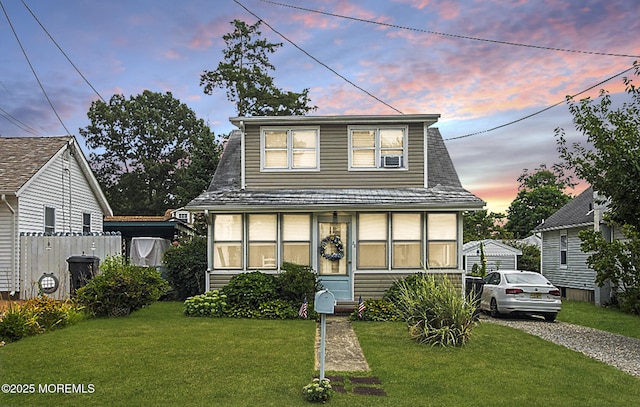 bungalow-style home with a yard