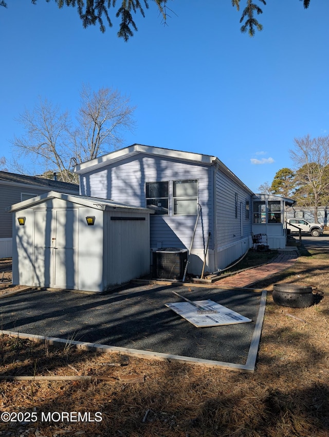 exterior space featuring a storage unit and central AC unit